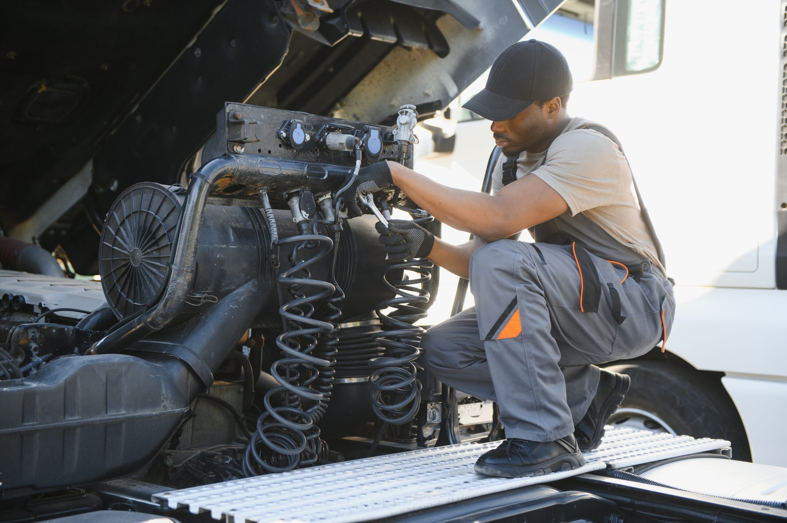 Professional Truck Mechanic Working in Vehicle